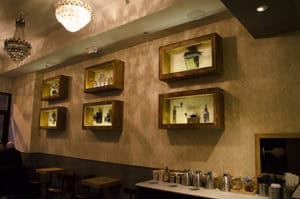 Decorative display shelves with plants and artifacts, warm lighting, chic interior design.