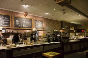 Cozy coffee shop ambiance with a variety of beverages and a modern counter setup.