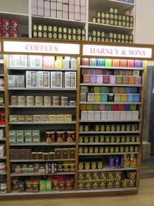 Colorful assortment of tea and coffee tins on display at Harney & Sons retail shop.