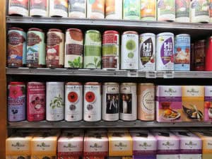 Vast selection of herbal teas and dietary supplements on store shelf for wellness and health goals.