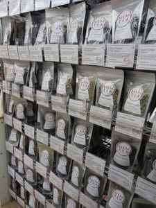 Assortment of premium herbal and flavored teas on retail store shelves, featuring various packaging and brands.