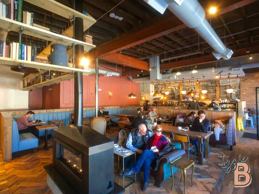 Modern café with warm lighting, wooden accents, and comfortable seating, ideal for coffee lovers and remote workers.