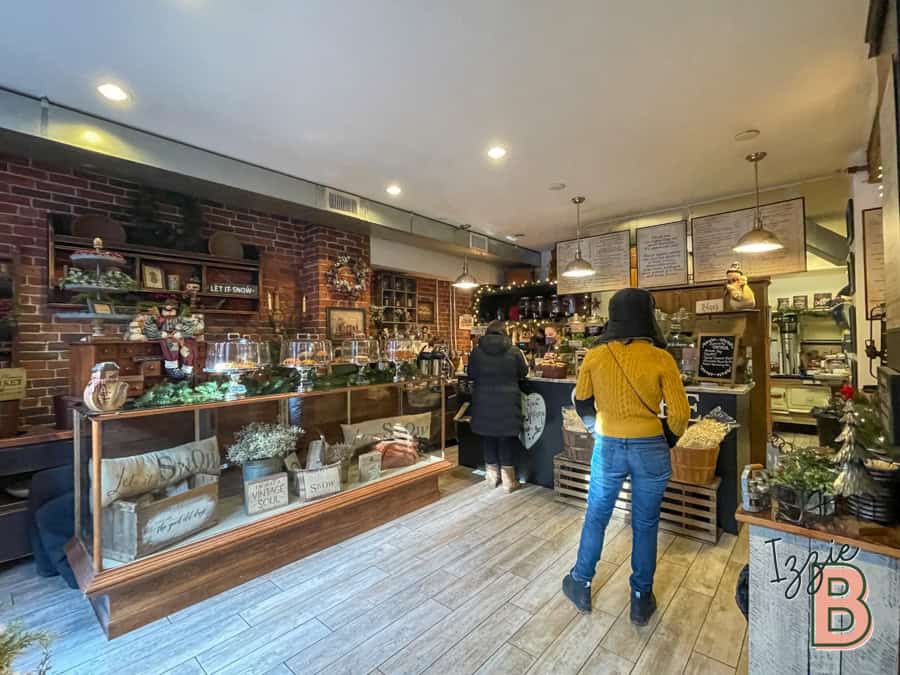 Inviting cafe interior with brick walls, warm lighting, and festive holiday decorations.