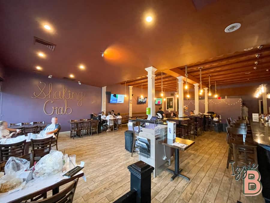 Stylish restaurant decor with wooden floors, warm lighting, and comfortable seating for guests.