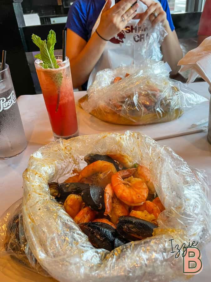 Seafood boil with shrimp and mussels in plastic bag, casual dining, fresh seafood, Izzy Bytes.