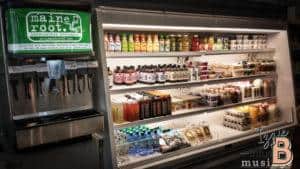 Organic drinks in a refrigerated display case at Maine Root handcrafted beverages.
