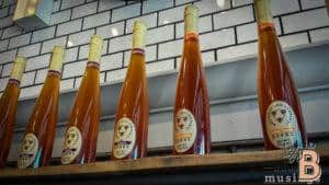 Natural honey bottles on a rustic shelf. Organic, raw honey from local bees. Perfect for health and wellness.