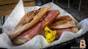 Close-up of a toasted ham sandwich with crispy bread and melted cheese. Perfect for lunch or snack.