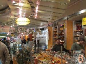 Bright spice and tea shop in mall bustling with customers and festive decorations.