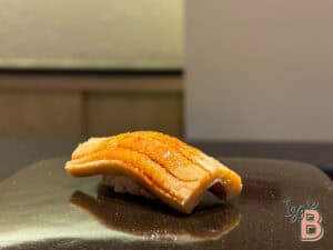 Fresh eel nigiri sushi featuring grilled eel glazed with teriyaki sauce.