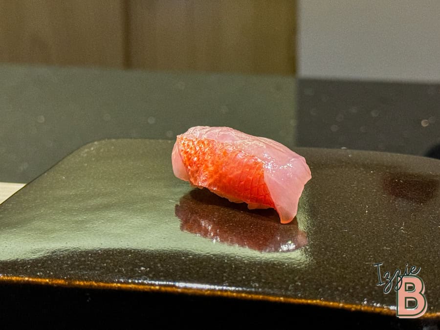 Fresh tuna sashimi served on black ceramic plate, showcasing premium seafood and sushi art, part of Japanese culinary delights, Izzie Bytes.