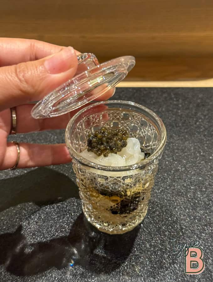 Luxury dessert with caviar and cream in a decorative glass, elegant presentation for fine dining.