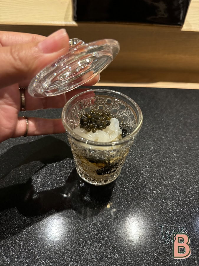 Delicious creamy dessert with caviar topping served in an ornate glass jar at Izzie Bytes.