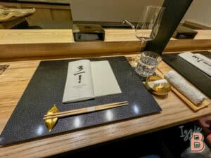 Elegant Japanese dining setup with chopsticks, glassware, and minimalist decor.