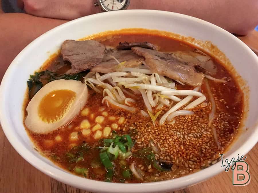 Rich spicy ramen with soft-boiled egg, bean sprouts, pork slices, and sesame seeds. Perfect comfort food.