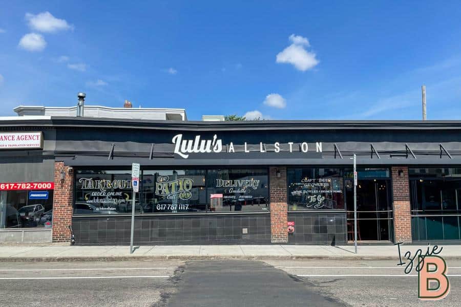 Bright daytime exterior of Lulu's Allston restaurant, showcasing takeout, dine-in, and delivery services.
