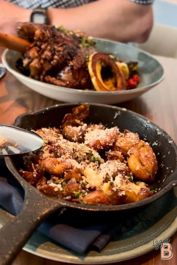 Delicious  truffled peewee potatoes topped with grated cheese, and fresh herbs in a rustic skillet. Perfect comfort food.