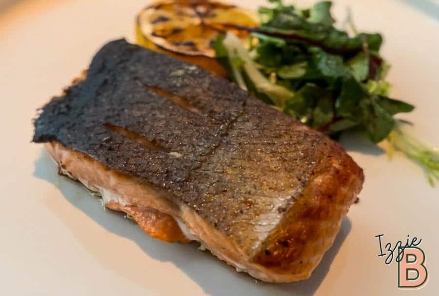 Healthy grilled salmon with crispy skin and side salad, perfect for a nutritious meal.