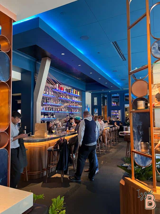 Bright, modern bar with vibrant blue lighting and contemporary decor.